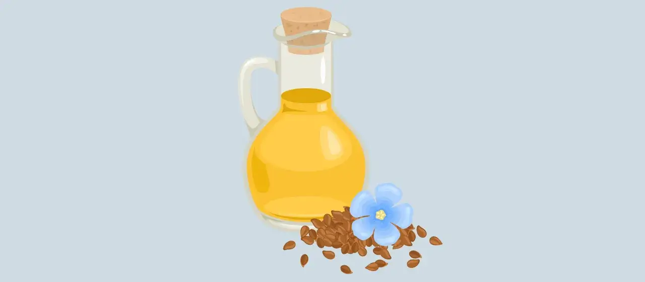 Szklana karafka z olejem lnianym, nasiona lnu i niebieski kwiatek. Olej lniany a wątroba – naturalne wsparcie.